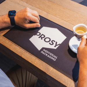 Isikupärastatud baarimatt kohviku letil, mis kaitseb pinda ja kuvab brändi logo