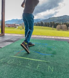 Roheline logoga väliporivaip golfiväljakul